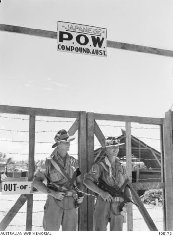 Australian guards with Owen Guns at gates of POW Compound on Morotai