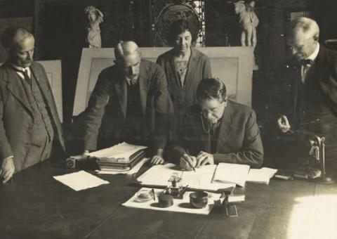 Richard Ball signs the contract in his office